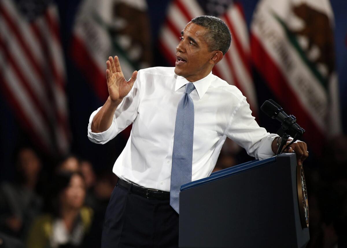 President Obama looks back at a man in the audience who asked Obama for help getting his family to the United States during his remarks concerning immigration reform from the Betty Ann Ong Chinese Recreation Center in San Francisco.