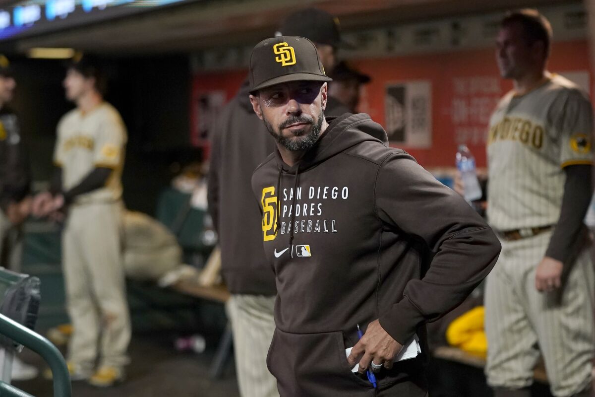 San Diego Padres manager Jayce Tingler stands in the dugout,