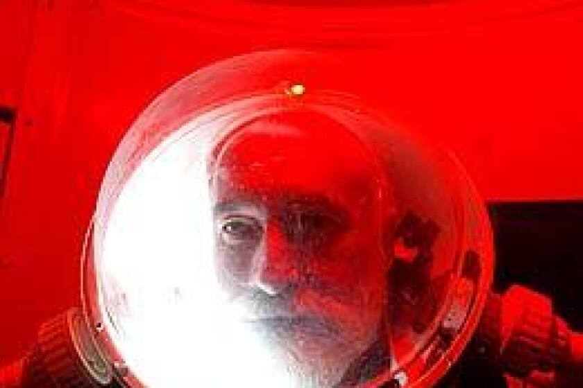 John Bergener, commander of a team of scientist and space enthusiasts at Mars Desert Research Station in Utah, under the red light of the station's air lock