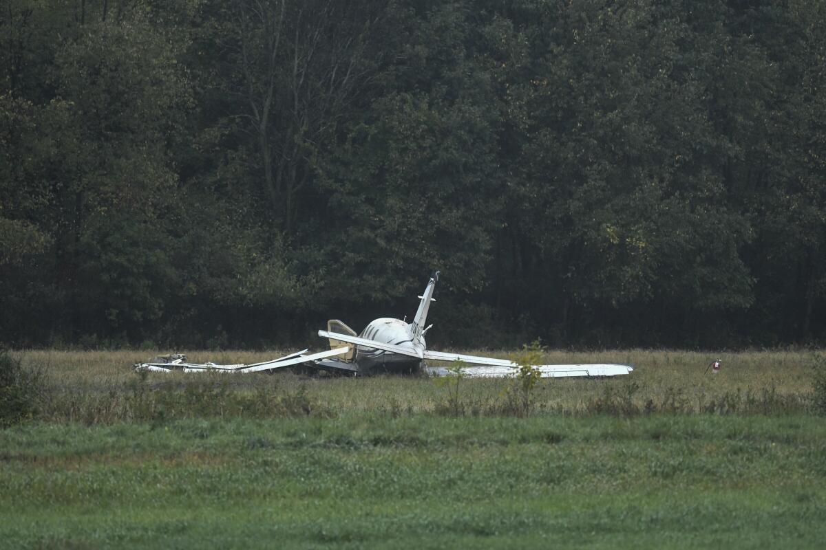 FILE - The scene just west of Capital Region International Airport where a small plane crashed Thursday, Oct. 3, 2019. Federal investigators blame pilot error and an overloaded aircraft for the 2019 plane crash near a Michigan airport that killed five Indiana men and seriously injured a sixth person aboard. (Matthew Dae Smith/Lansing State Journal via AP)