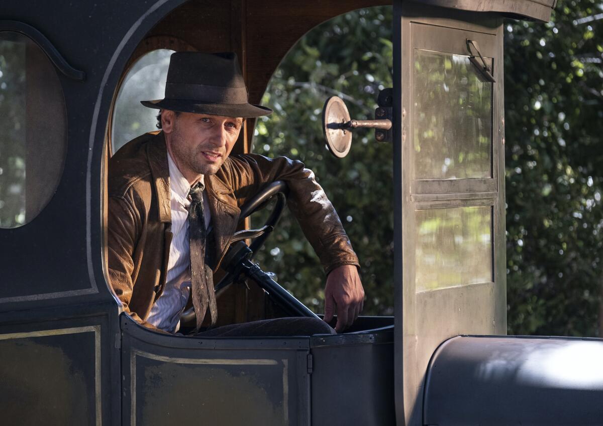 Matthew Rhys looking out of the window of a 1920s auto in "Perry Mason."