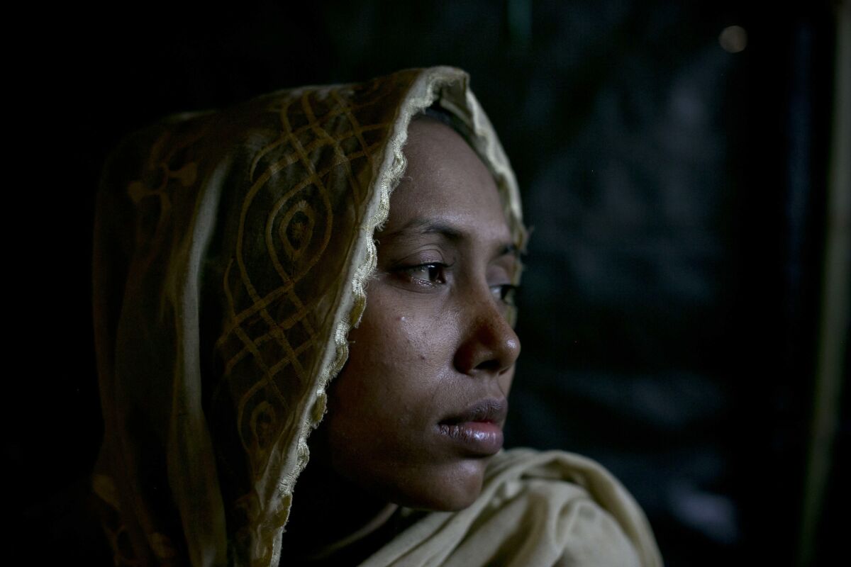 Yasmin on the floor of her home in Balu Kali refugee camp in Cox's Bazar, Bangladesh. She escaped from her home in the Naine Chong Village in Myanmar after the Myanmar military attacked her village.