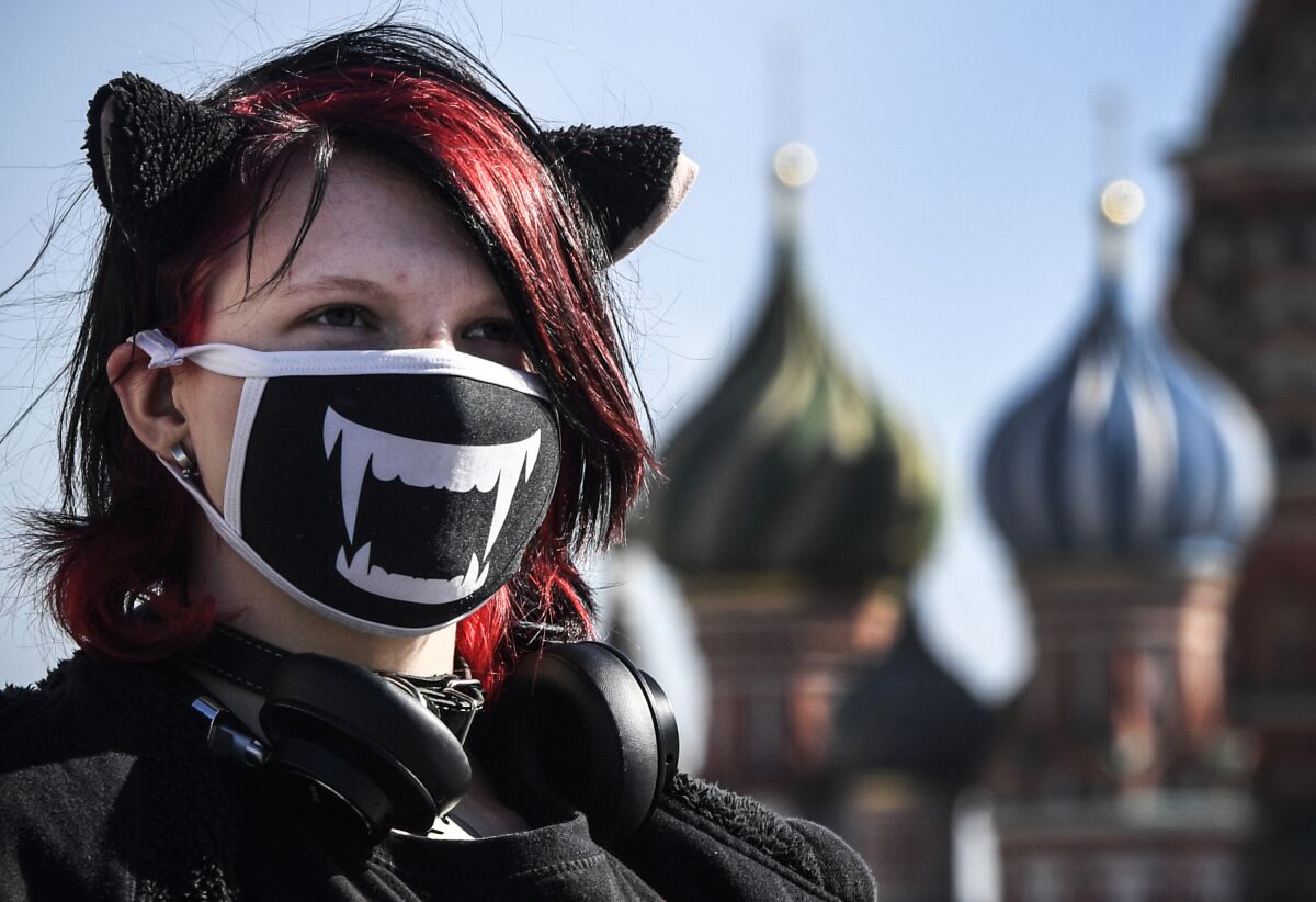 RUSSIA - A young woman wearing a face mask, amid concerns over the spread of the COVID-19 coronavirus, walks on Red Square in Moscow, Russia.
