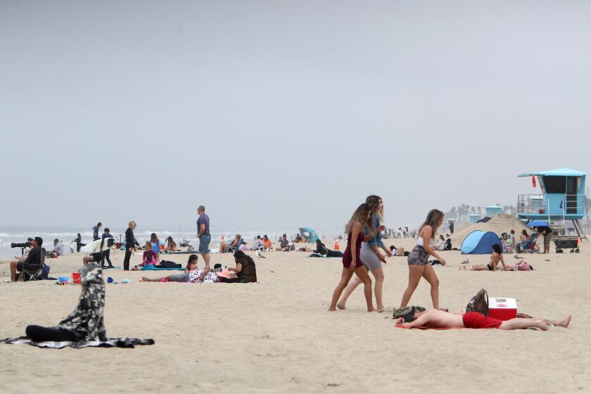 Light crowds were on the sand at Huntington City Beach, in Huntington Beach, on Thursday, April 30, 2020. California Gov. Gavin Newsom said all state and local beaches in Orange County must close.