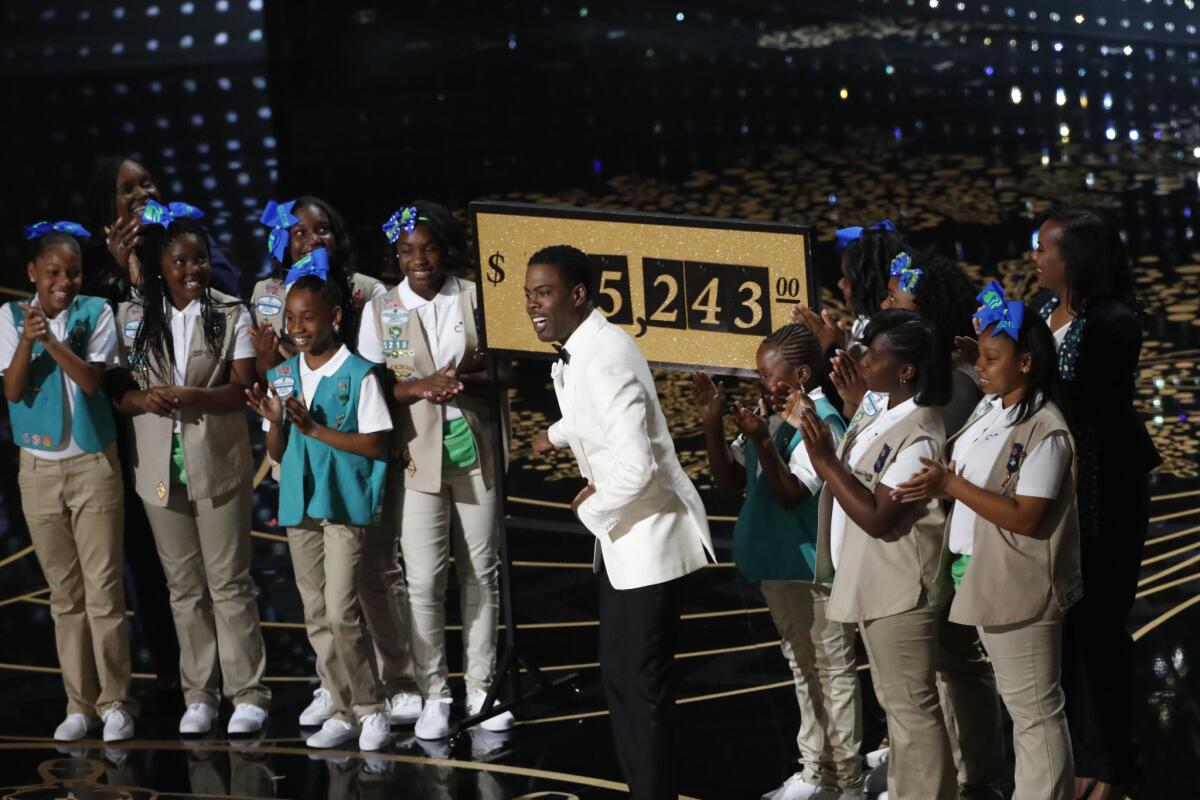 Chris Rock and Girl Scouts from an Inglewood troop. during the telecast of the 88th Academy Awards on Sunday. Money raised during the show will go to an Inglewood troop.