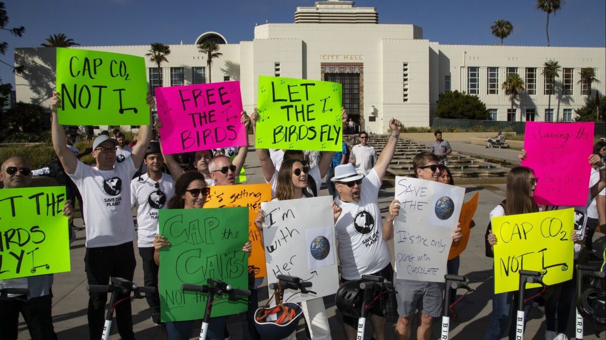 Demonstrators gather outside Santa Monica City Hall on Tuesday to support scooter company Bird.