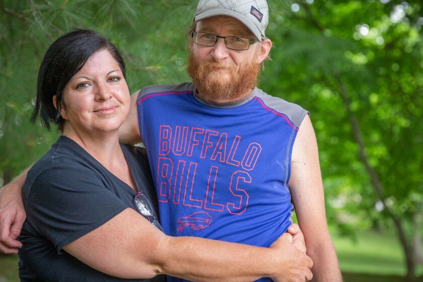 Wendy Matney, left, poses for a portrait with husband Steve Matney at Steele Creek Park in Bristol, Tenn., United States, Wednesday, May 29, 2019. Wendy, who suffers from partial and tonic clonic epileptic seizures, and her husband Steve are filing for bankruptcy because the hospital and ambulance fees they have acquired, a total of about $25,000, are too great for them to pay off. "I know that it is my debt and I know that bankruptcy is cheating people," Wendy said, " It is my fault, but it is not something I intended."
