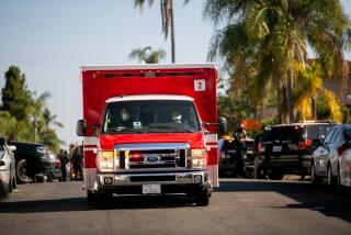 SAN DIEGO, CA - JULY 09: An American Medical Response ambulance drives past San Diego Police Department officers responding to the scene of an officer-involved shooting on the 4300 block of Menlo Avenue on Thursday, July 9, 2020 in San Diego, CA. (Sam Hodgson / The San Diego Union-Tribune)
