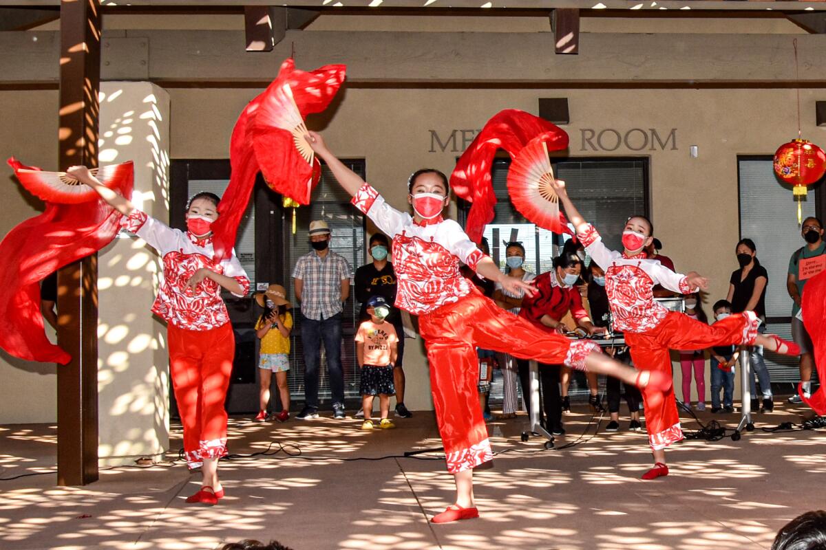 Young dancers from the San Diego Hua Xia Chinese School perform artistic ribbon and fan dances.