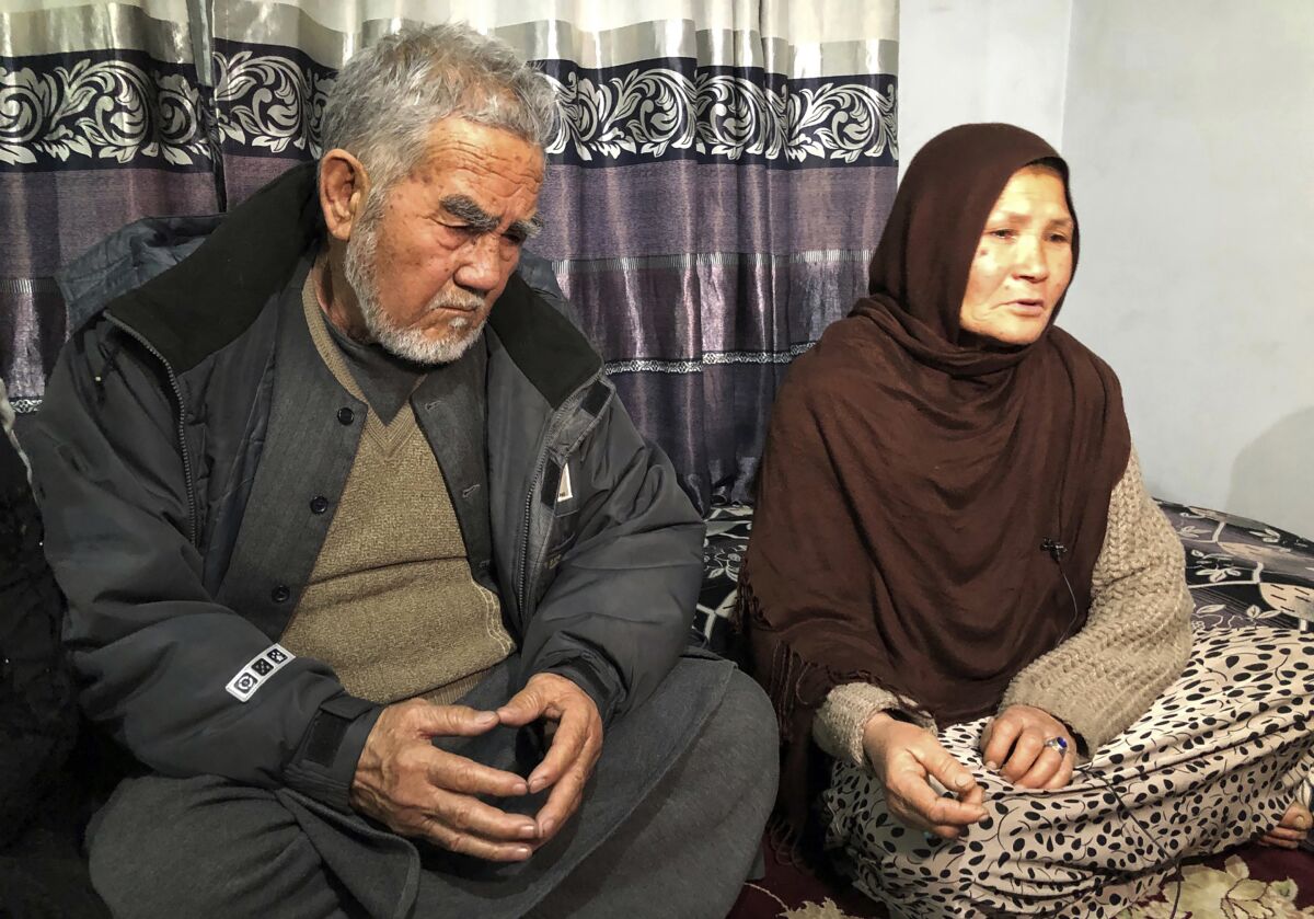 Zenaib Abdullahi's mother Mariam, right, and father father Nadir Ali, give an interview to The Associated Press at their family home in Kabul, Afghanistan, Jan. 17, 2022. On a recent night in Kabul, a Taliban security guard at a checkpoint in Kabul opened fire on a car carrying Zenaib's family home from a wedding, killing 25-year-old Zenaib. Taliban officials say the shooting was a mix-up. But Zeinab’s death highlights one dilemma facing Afghanistan’s new rulers as they move from waging an insurgency to governing. (AP Photo/Mohammed Shoaib Amin)