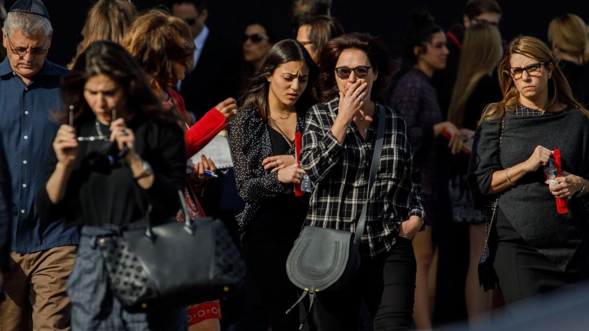 Mourners gather outside after attending a memorial service Monday for Blaze Bernstein at University Synagogue in Irvine.