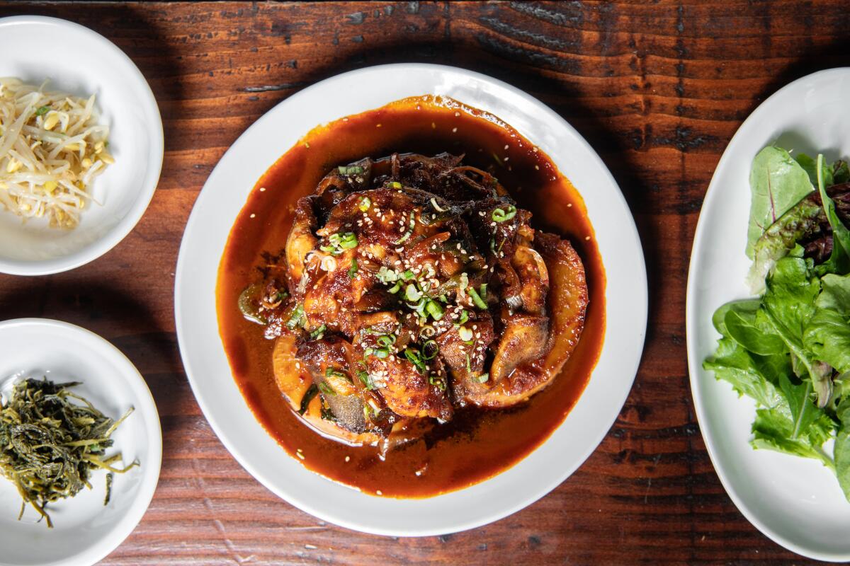 An overhead photo of braised cod atop a wooden table at Jun Won restaurant, taken in 2019. 