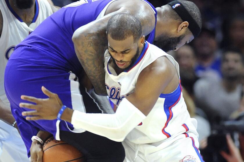 Chris Paul tries to steal the ball from Sacramento's DeMarcus Cousins in February.