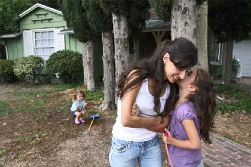 AT HOME: Hedy Maar and daughters Leylah, left, and Sarah. A first-time-buyer program helped the Maars to buy their $479,950 Granada Hills home.