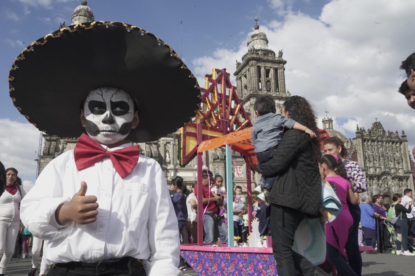 Dilan Bautista, 4, joins the festivities during Mexico City’s first Day of the Dead parade. More than 250,000 people attended.