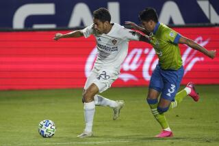 LA Galaxy forward Ethan Zubak, left, gets control of the ball next to Seattle Sounders defender Xavier Arreaga during the first half of an MLS soccer match Wednesday, Nov. 4, 2020, in Carson, Calif. (AP Photo/Ashley Landis)