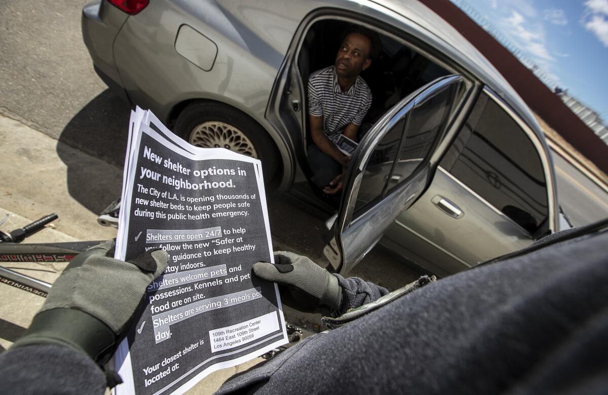 St. Joseph Center case manager John Cudal talks with a homeless man.