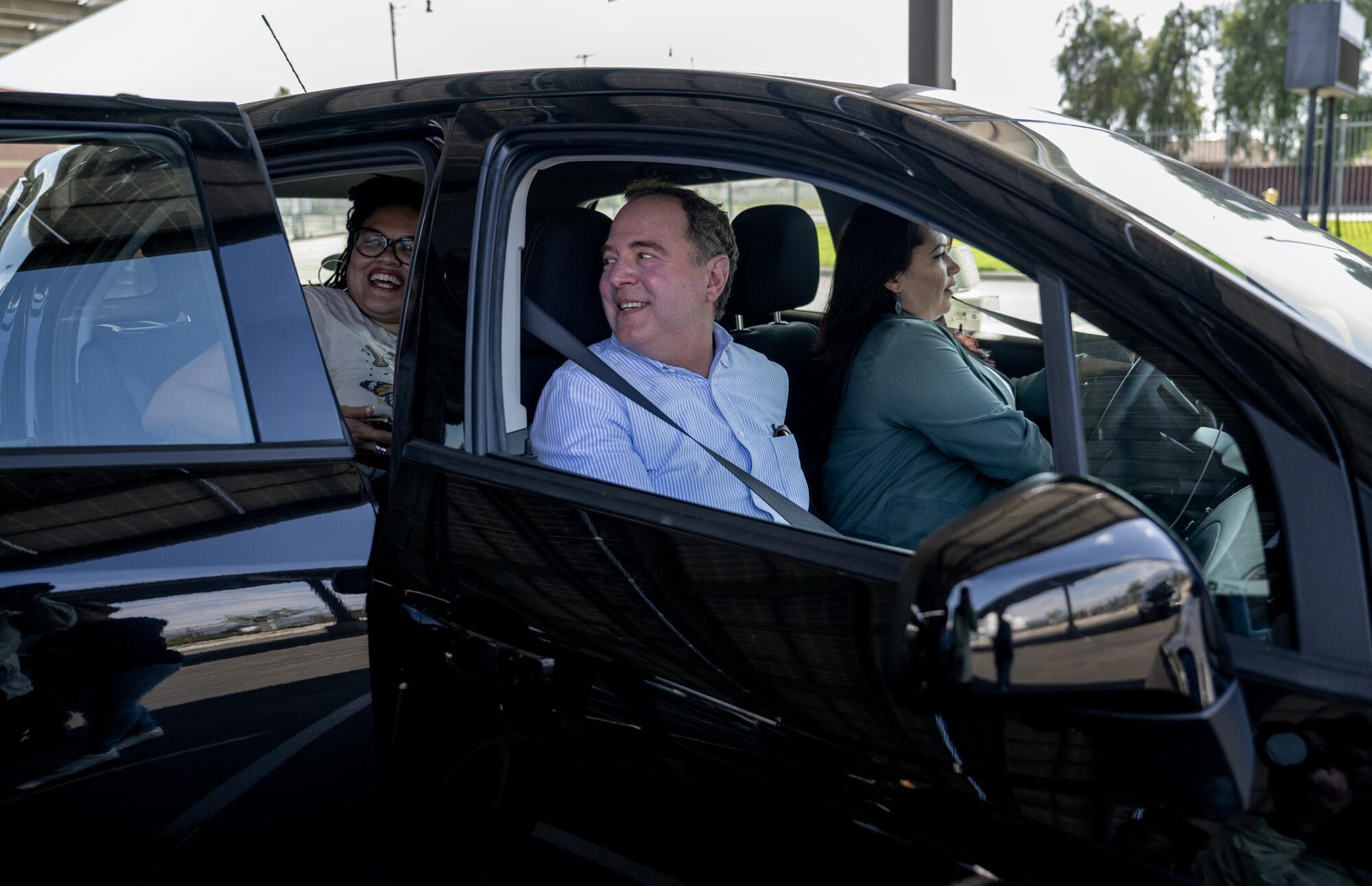 Congressman Adam Schiff (D-Calif) gets into a car with community activists