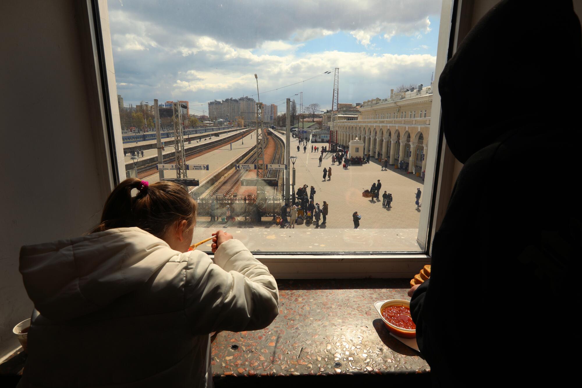 Children being evacuated from Ukraine receive a meal at the train station in Odesa before the next leg of their journey.