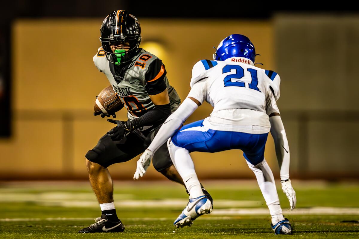 Huntington Beach's Nicolas Navarrete tries to get around Santi Bautista of La Habra on Friday in an Epsilon League game.