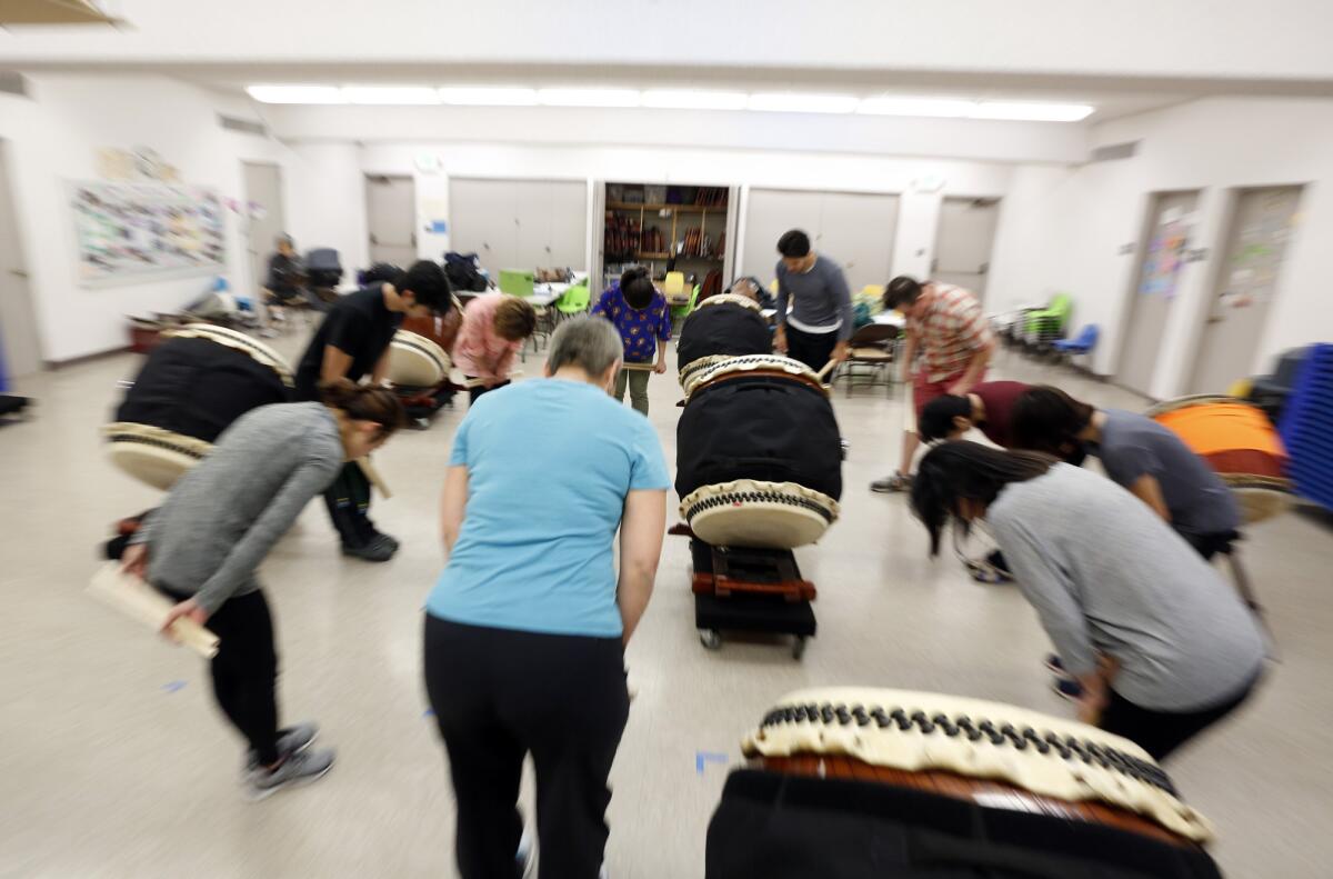 Participants bow at the end of a TaikoProject drumming class.