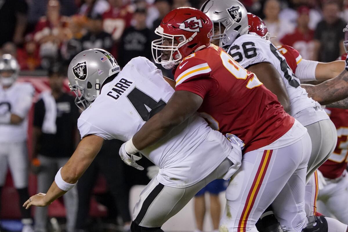 Las Vegas Raiders quarterback Derek Carr (4) is sacked by Kansas City Chiefs defensive tackle Chris Jones, right, during the first half of an NFL football game Monday, Oct. 10, 2022, in Kansas City, Mo. (AP Photo/Ed Zurga)
