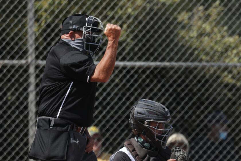 Plate umpire Jeff Sill calls a strike during a game between Thousand Oaks and Newbury Park on May 17.