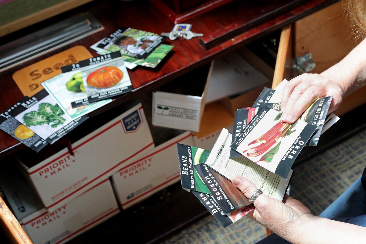 Seed librarian Sheryl Kellner sorts out donations at Huntington Beach Central Library Tuesday, May 4, 2021.