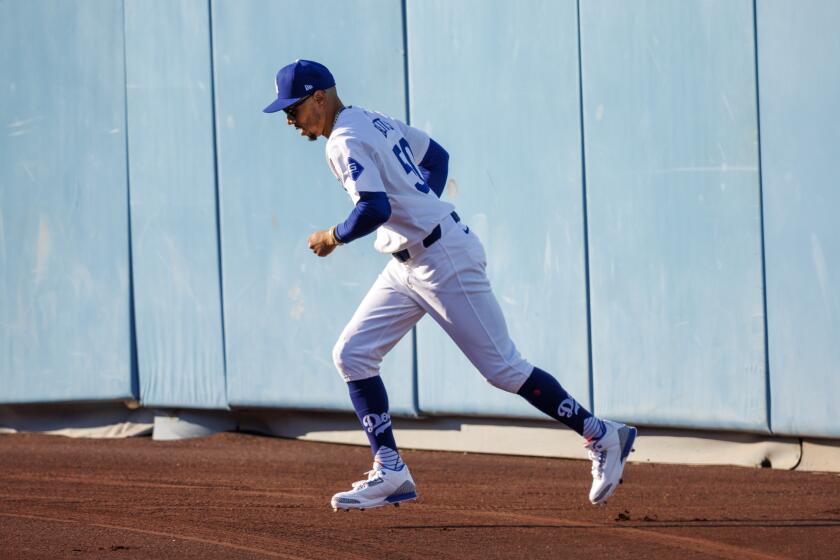 LOS ANGELS, CA - OCTOBER 6, 2024: Los Angeles Dodgers right fielder Mookie Betts (50) warms up.