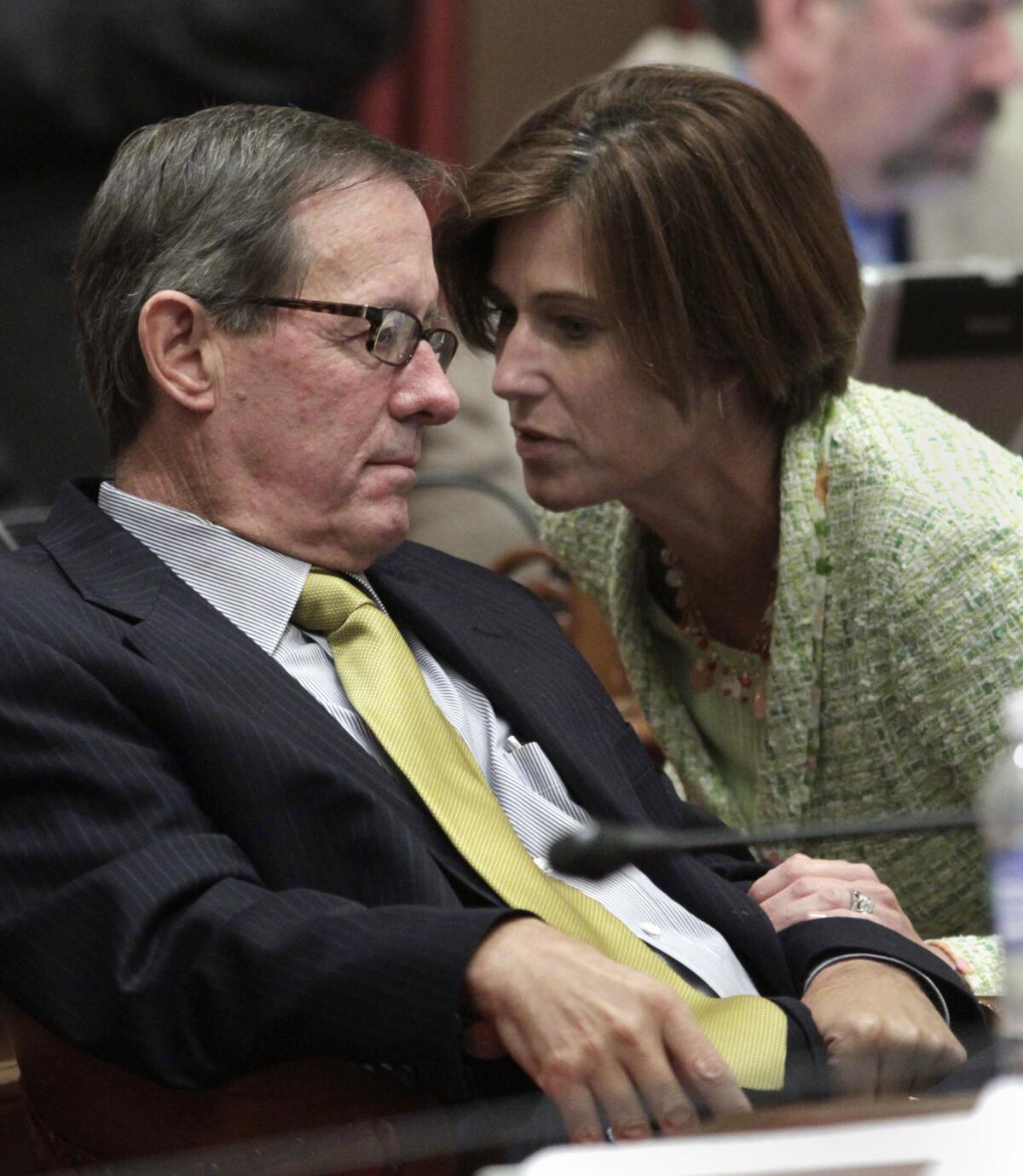 Republican state Sens. Tom Berryhill (R-Modesto) and Mimi Walters (R-Lake Forest)confer during a recent floor debate on the budget. Berryhill faces administrative charges of laundering campaign contributions to his brother.