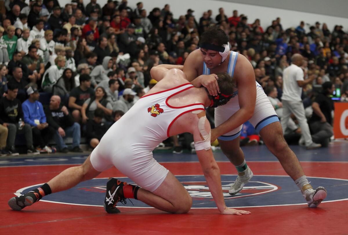 Corona del Mar’s Emilio Franco, right, competes for third place in a 220-pound medal-round match during the CIF Southern Section Masters Meet at Sonora High in La Habra on Feb. 22.