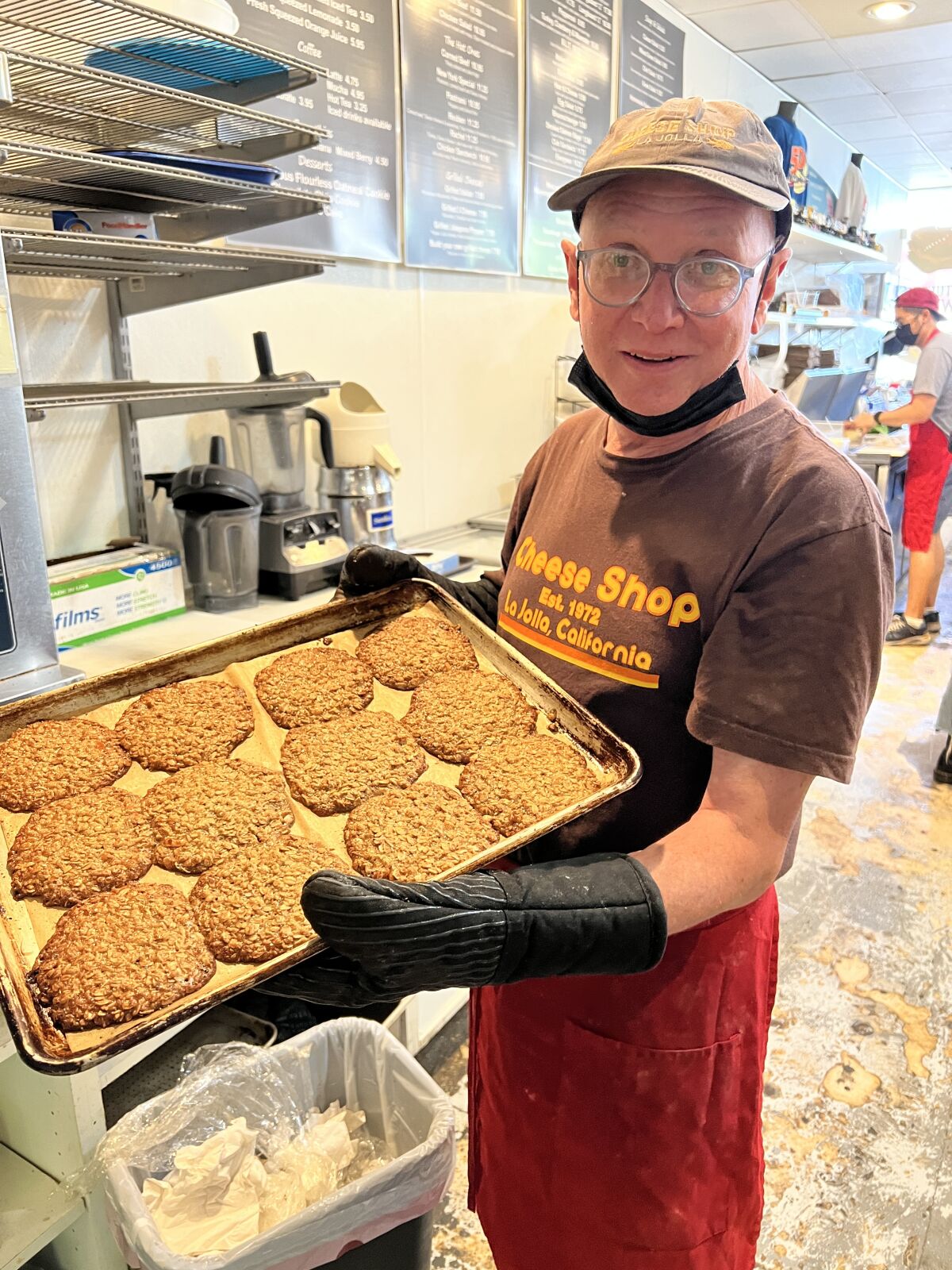 Cheese Shop co-owner Dave Schutz shows the establishment's popular oatmeal almond cookies.