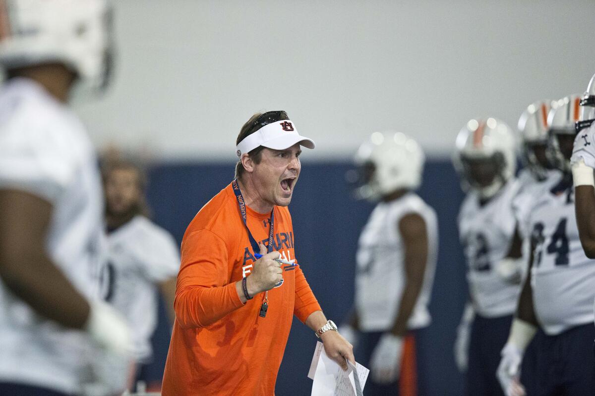 Auburn Defensive Coordinator Will Muschamp screams at a player during an indoor practice Aug. 4.