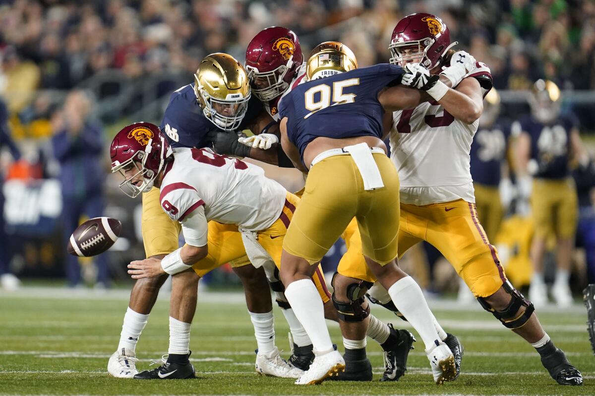 USC quarterback Kedon Slovis fumbles the ball against Notre Dame