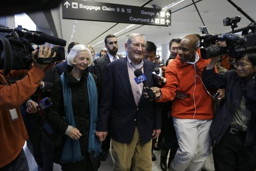 Merrill Newman, shown with h is wife, Lee, speaks with reporters after arriving at San Francisco International Airport on Saturday.