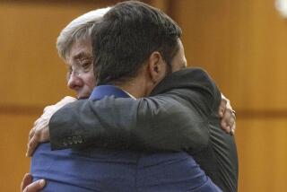 Tacoma Police officer Christopher "Shane" Burbank, right, gets a hug from his attorney Wayne Fricke after he is declared not guilty for any charges related to the March 2020 killing of Manny Ellis in Pierce County Superior Court in Tacoma, Wash., Thursday, Dec. 21, 2023. (Ellen M. Banner/The Seattle Times via AP, Pool)