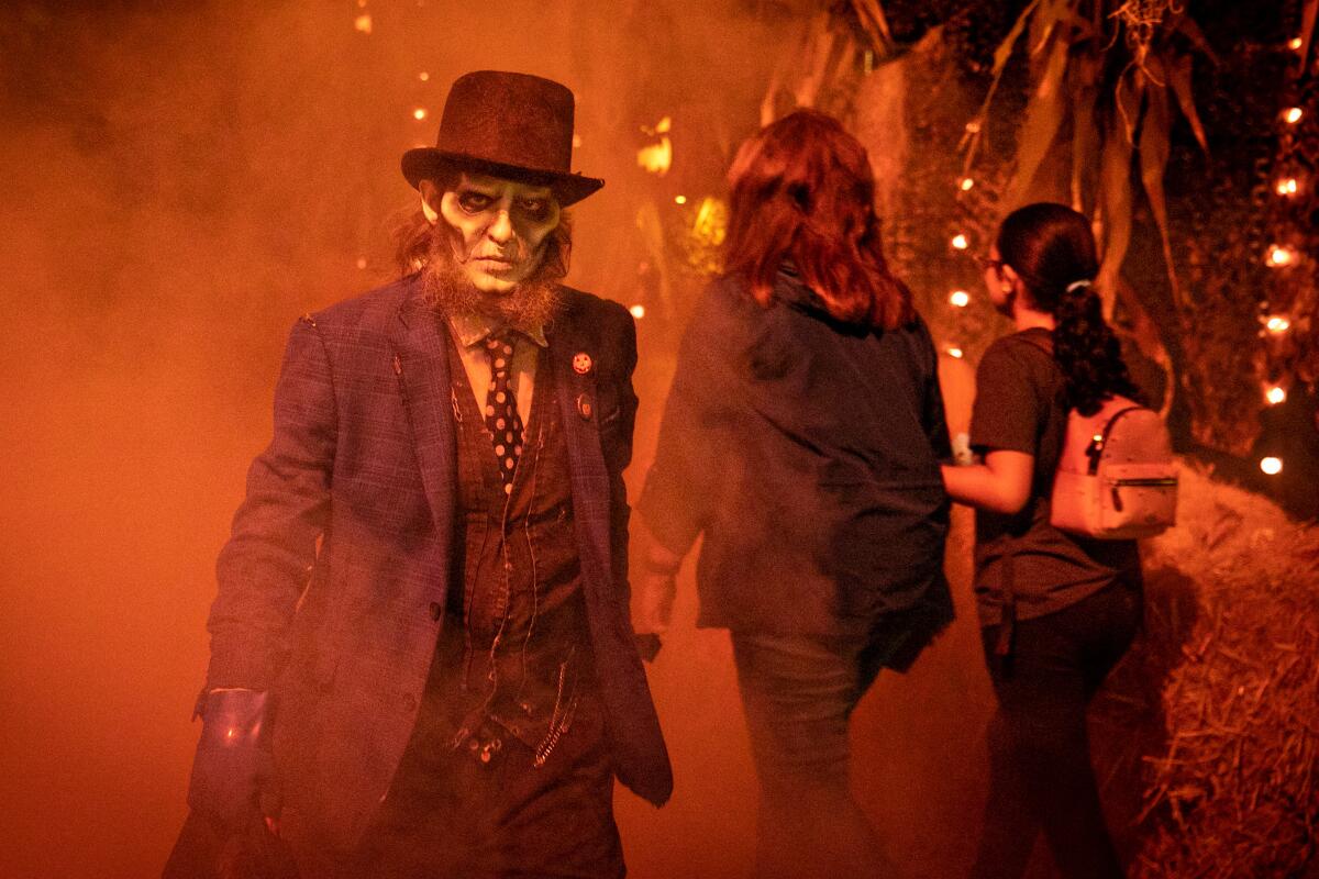 An actor waits for guests to ride the Haunted Hayride in Griffith Park.