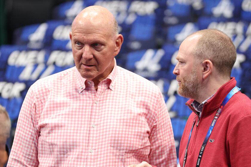 Clippers owner Steve Ballmer, left, talks to president of basketball operations Lawrence Frank before a playoff game.