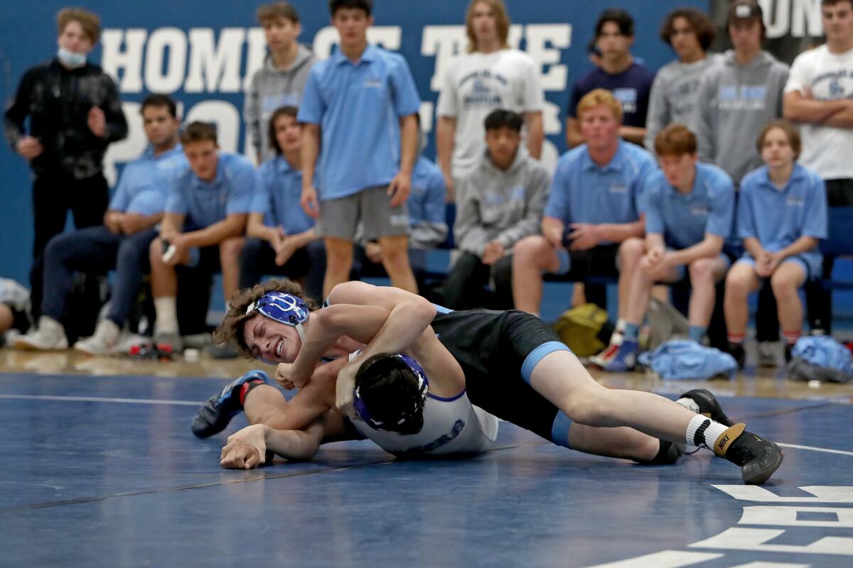 Corona del Mar's Zion Hernandez, top, wrestles Western's Isaiah Mota during the 145-pound match in the CIF Division 6 final.