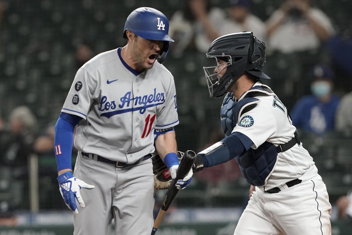 Dodgers batter AJ Pollock reacts after striking out during the sixth inning of a 4-3 loss to the Seattle Mariners on Monday.
