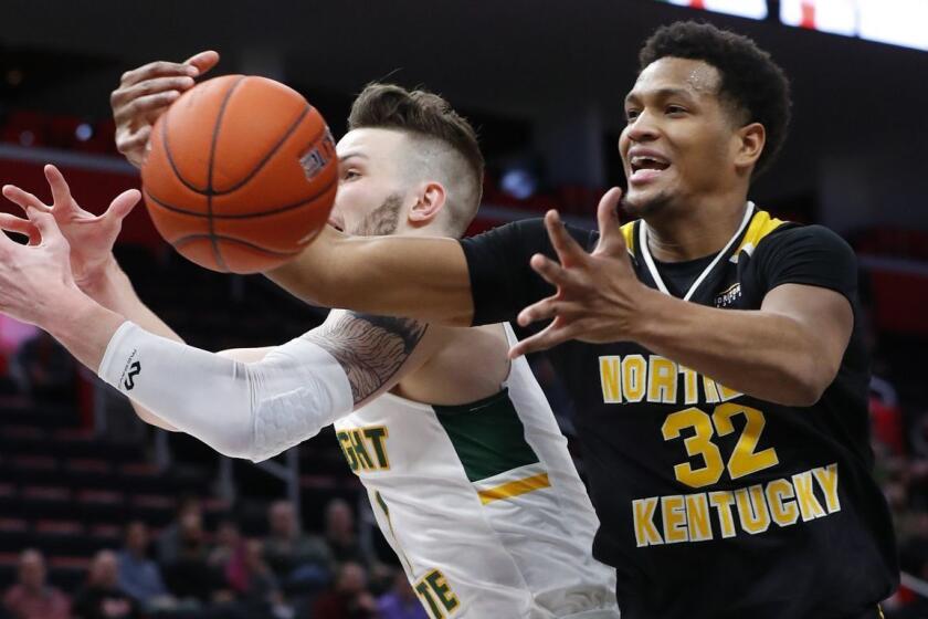 Northern Kentucky forward Dantez Walton (32) pulls down a rebound from Wright State forward Billy Wampler (1) in the first half of an NCAA men's basketball game in the Horizon League conference tournament championship in Detroit, Tuesday, March 12, 2019. (AP Photo/Paul Sancya)