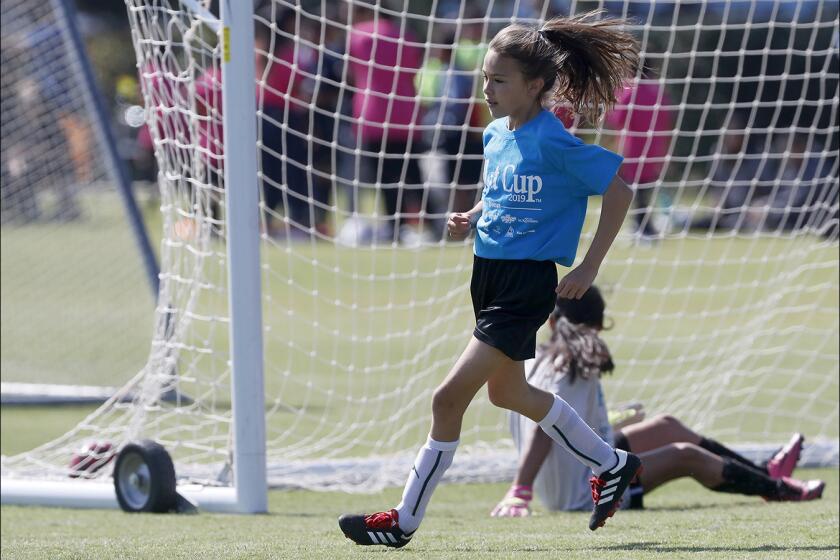 Costa Mesa Victoria Elementary's Adrianna Ramirez jogs back after kicking the ball into the left corner of the net against Costa Mesa Whittier in a girls’ third- and fourth-grade Silver Division pool-play match at the Daily Pilot Cup on Thursday at Jack R. Hammett Sports Complex in Costa Mesa.