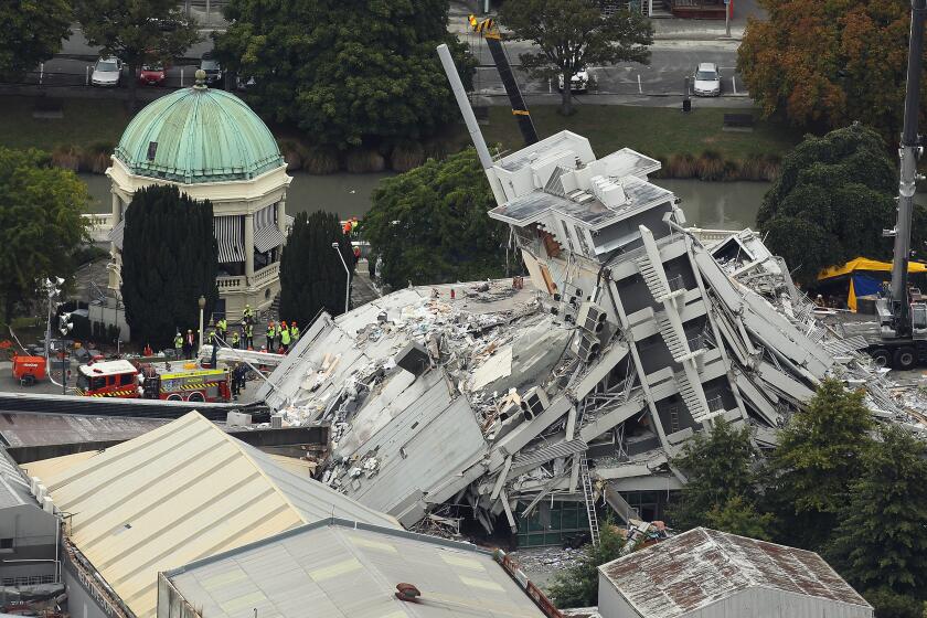 CHRISTCHURCH, NEW ZEALAND - FEBRUARY 23: Rescue workers surround the Pyne Gould Guiness building on February 23, 2011 in Christchurch, New Zealand. A massive search and rescue mission is underway and least 75 people have died after a 6.3 magnitude earthquake struck 20km southeast of Christchurch at around 1pm local time on Tuesday. The quake, which was an aftershock of a 7.1 magnitude quake which struck the South Island city on September 4, 2010, has seen damage and fatalities far exceeding those of the original. (Photo by Hannah Johnston/Getty Images)