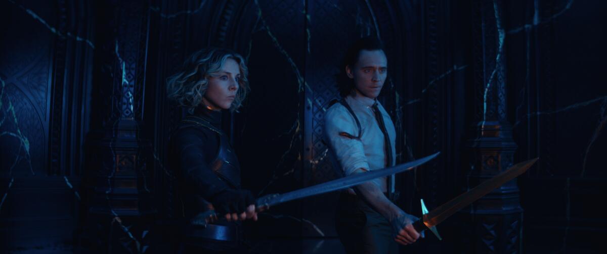 A woman and a man with their swords drawn