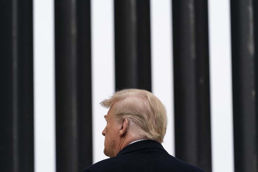 FILE - In this Jan. 12, 2021, file photo, President Donald Trump tours a section of the U.S.-Mexico border wall in Alamo, Texas. During the Trump administration's final weeks, the Department of Homeland Security quietly signed agreements with at least four states that threaten to temporarily derail President Joe Biden's efforts to undo his predecessor's immigration policies. (AP Photo/Alex Brandon, File)