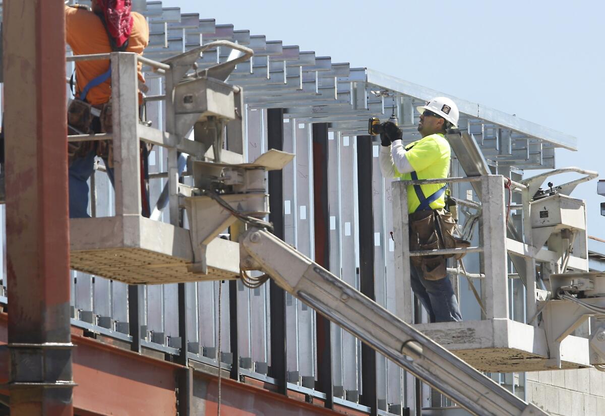 State job markets turned in mixed performances in July. Payroll jobs rose in 32 states, but unemployment rates climbed in 28. Above, construction workers in Sacramento.