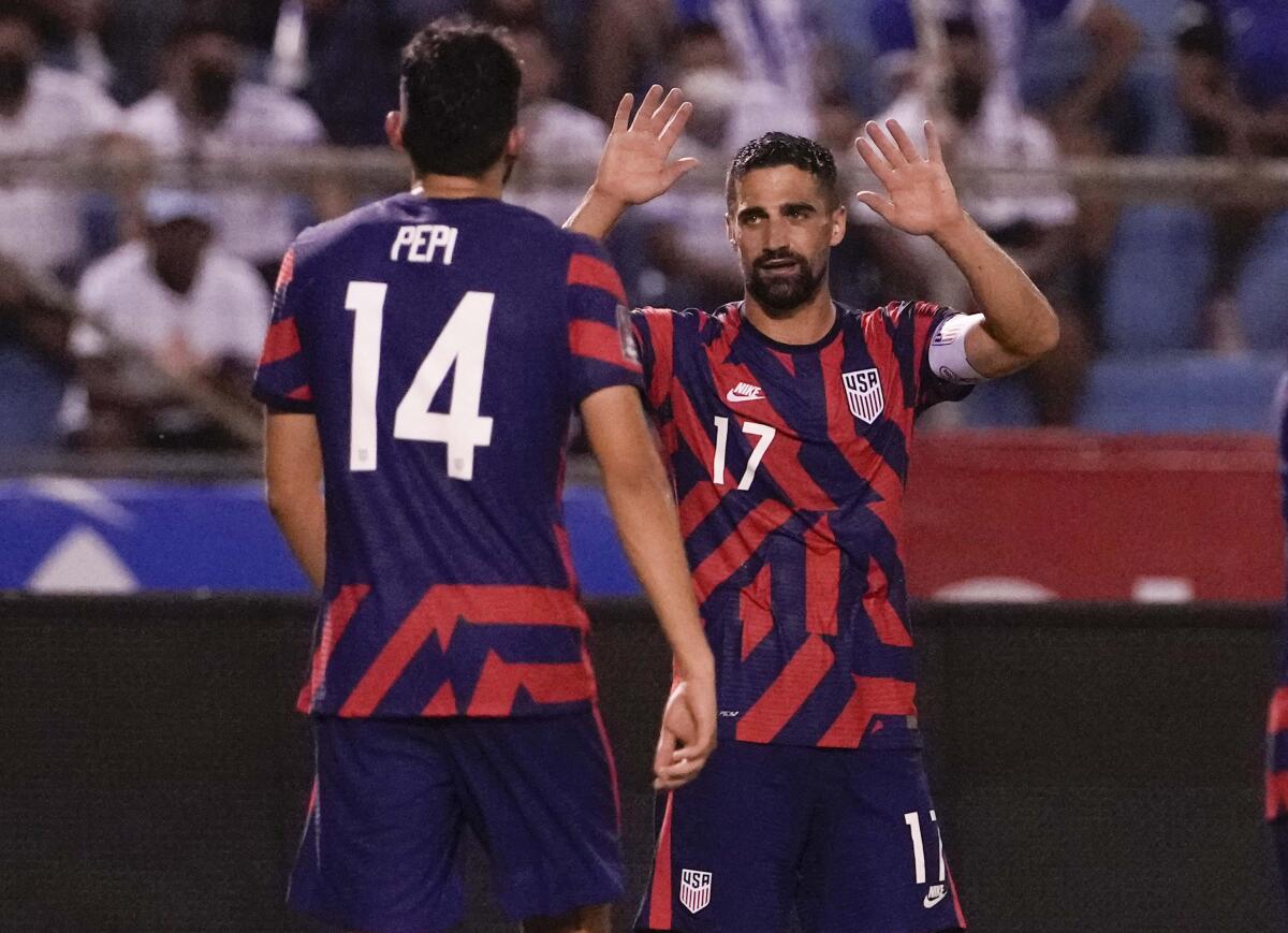 United States' Sebastian Lletget celebrates with his teammate Ricardo Pepi after scoring his side's fourth goal.