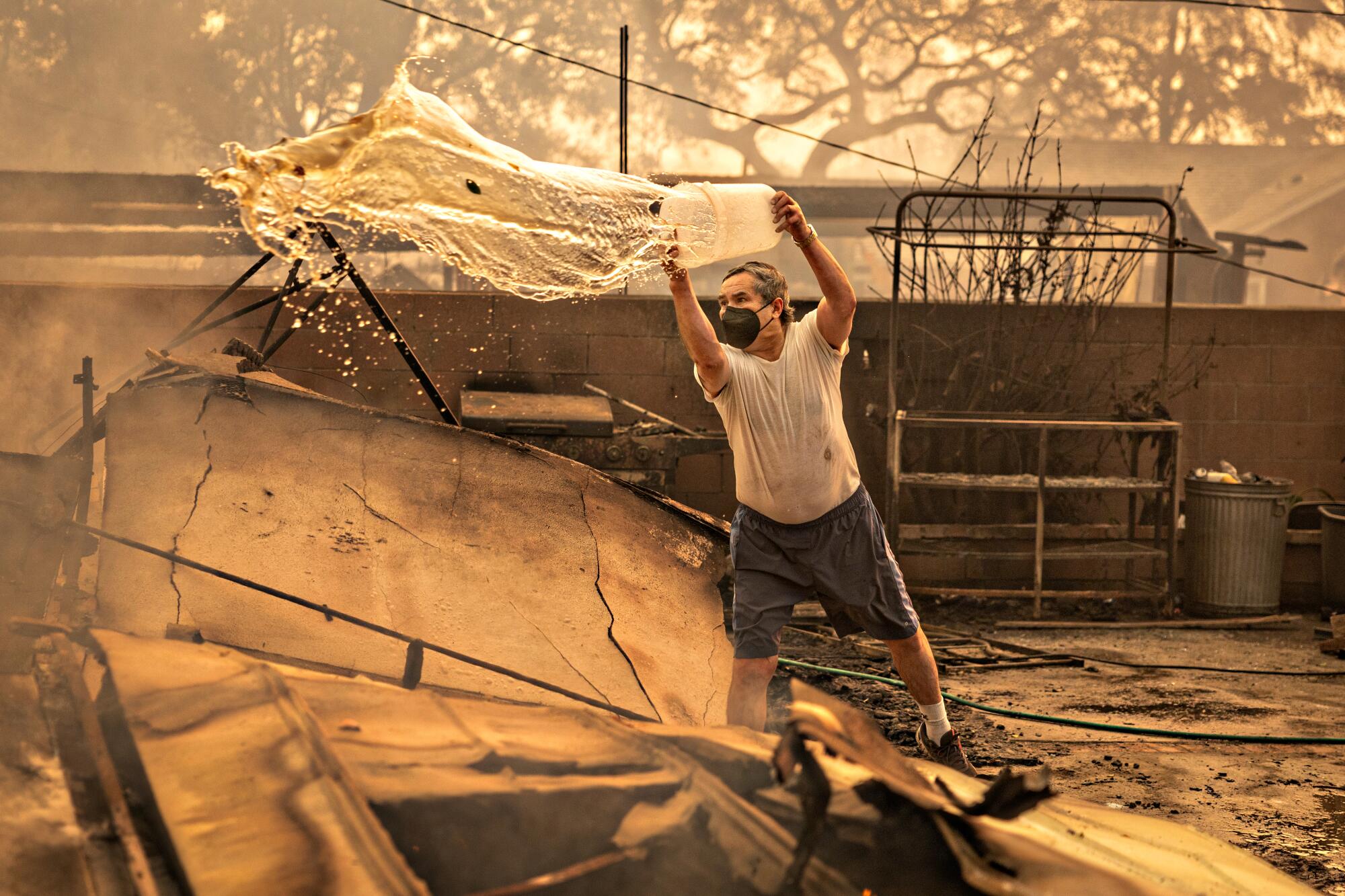 A man throws water from a bucket.