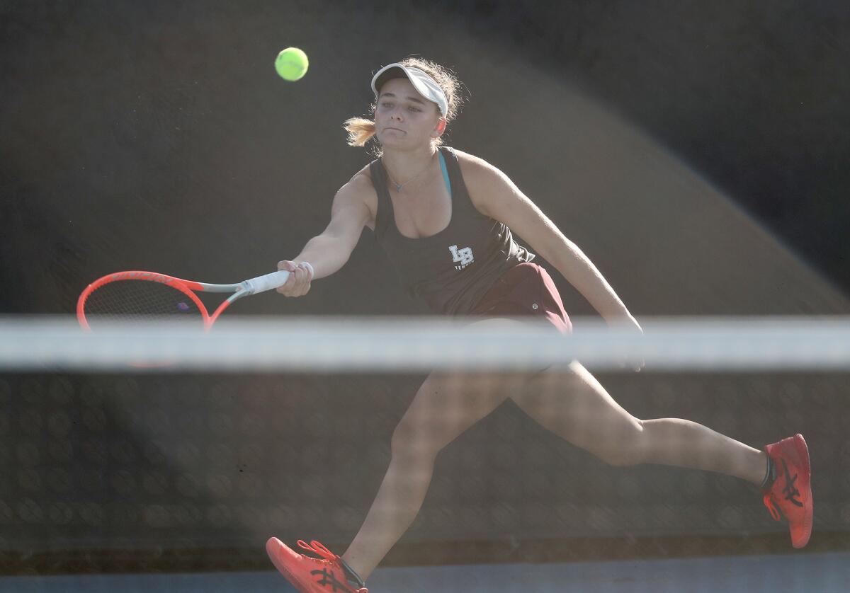 Laguna Beach's Sarah MacCallum returns a volley against Corona del Mar.