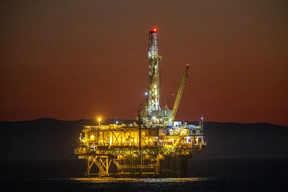A view of oil platform Emmy off the coast of Huntington Beach at dusk Thursday, October 14, 2021. 